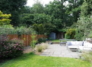Lawn with patio area and jasmine planted archway