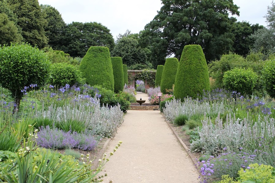 Herbaceous borders with central path leading to fountain