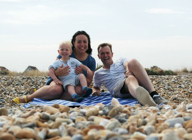 Me, Max and John sat on picnic rug on pebble beach