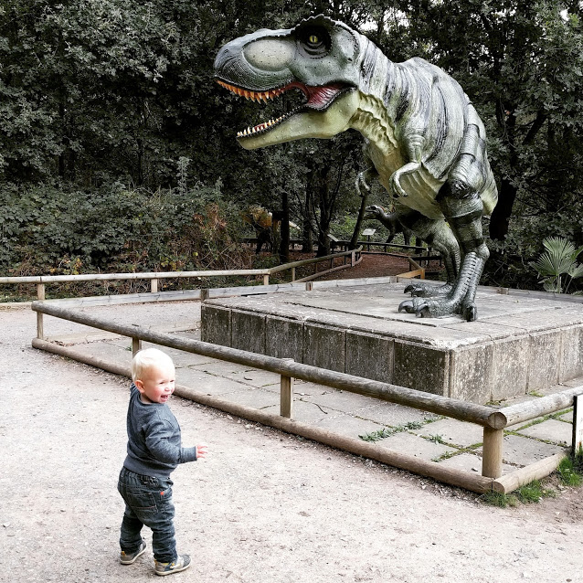 Max in front of giant T-Rex, pointing excitedly