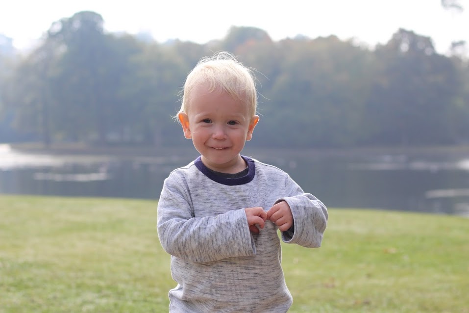 Max putting stones in his pocket, with little grin on his face