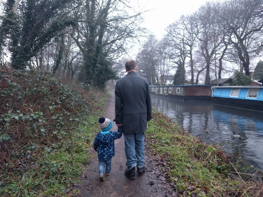 Max and John walking along the canal bank holding hands