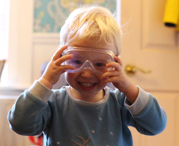 Max wearing safety goggles with massive smile on his face