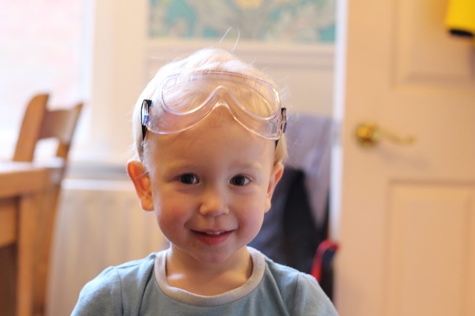 Max wearing pyjamas with safety goggles on his head