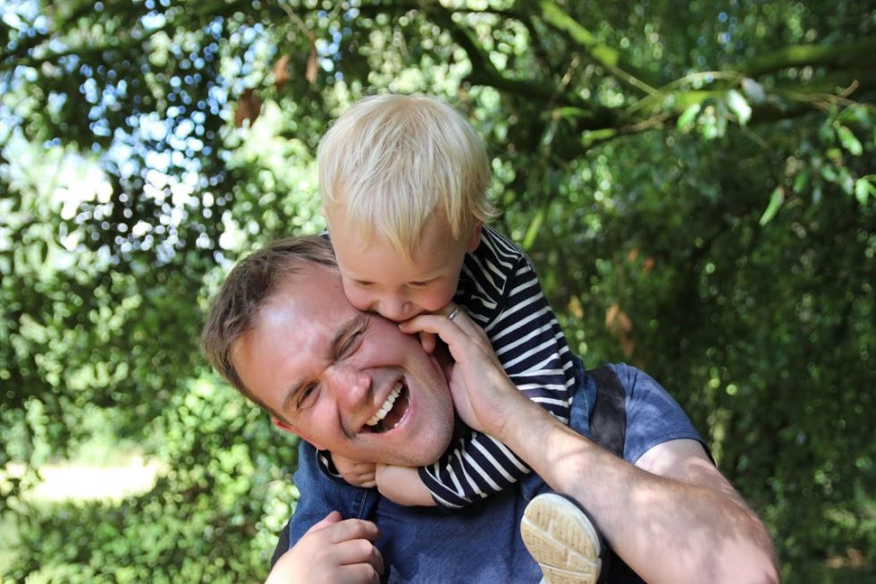 John with Max on his shoulders, both laughing