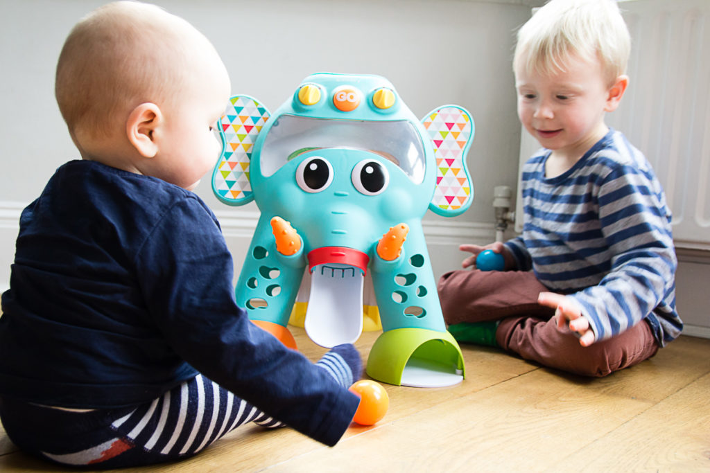 Two boys playing together with the Infantino Cruise Around Activity Elephant