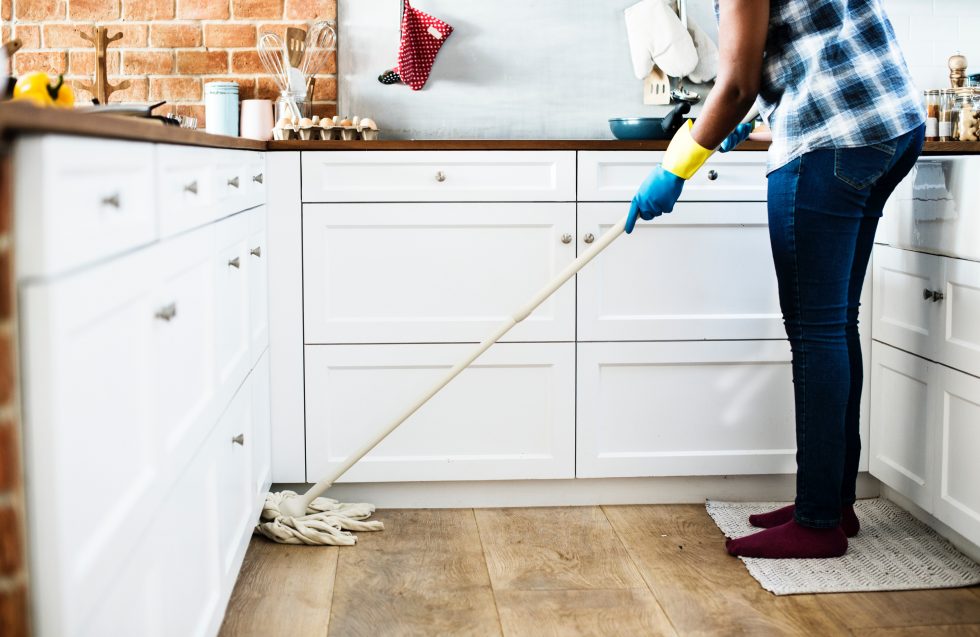Person mopping the floor in kitchen
