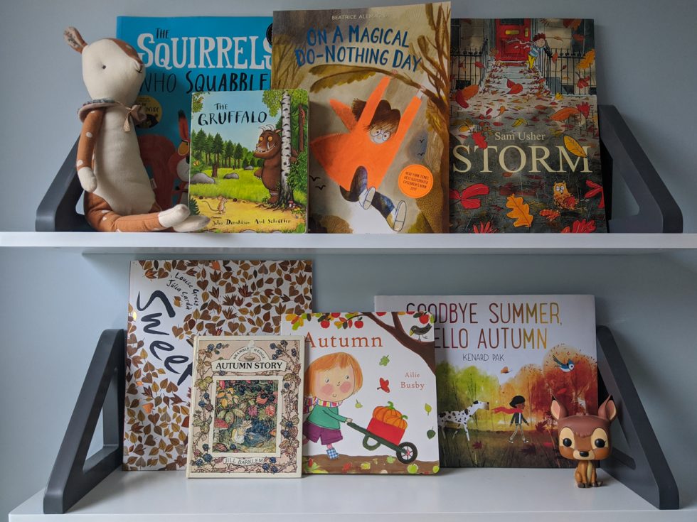 An autumn children's bookshelf, including The Squirrels That Squabbled, On A Magical Do Nothing Day, Storm, Sweep, Autumn Story, Autumn, Goodbye Summer, Hello Autumn